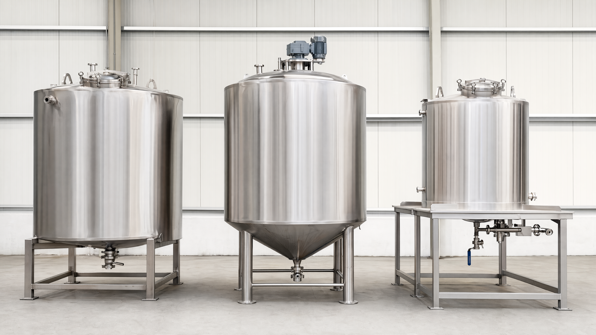 Representative lineup of three distinct completed stainless-steel tank configurations